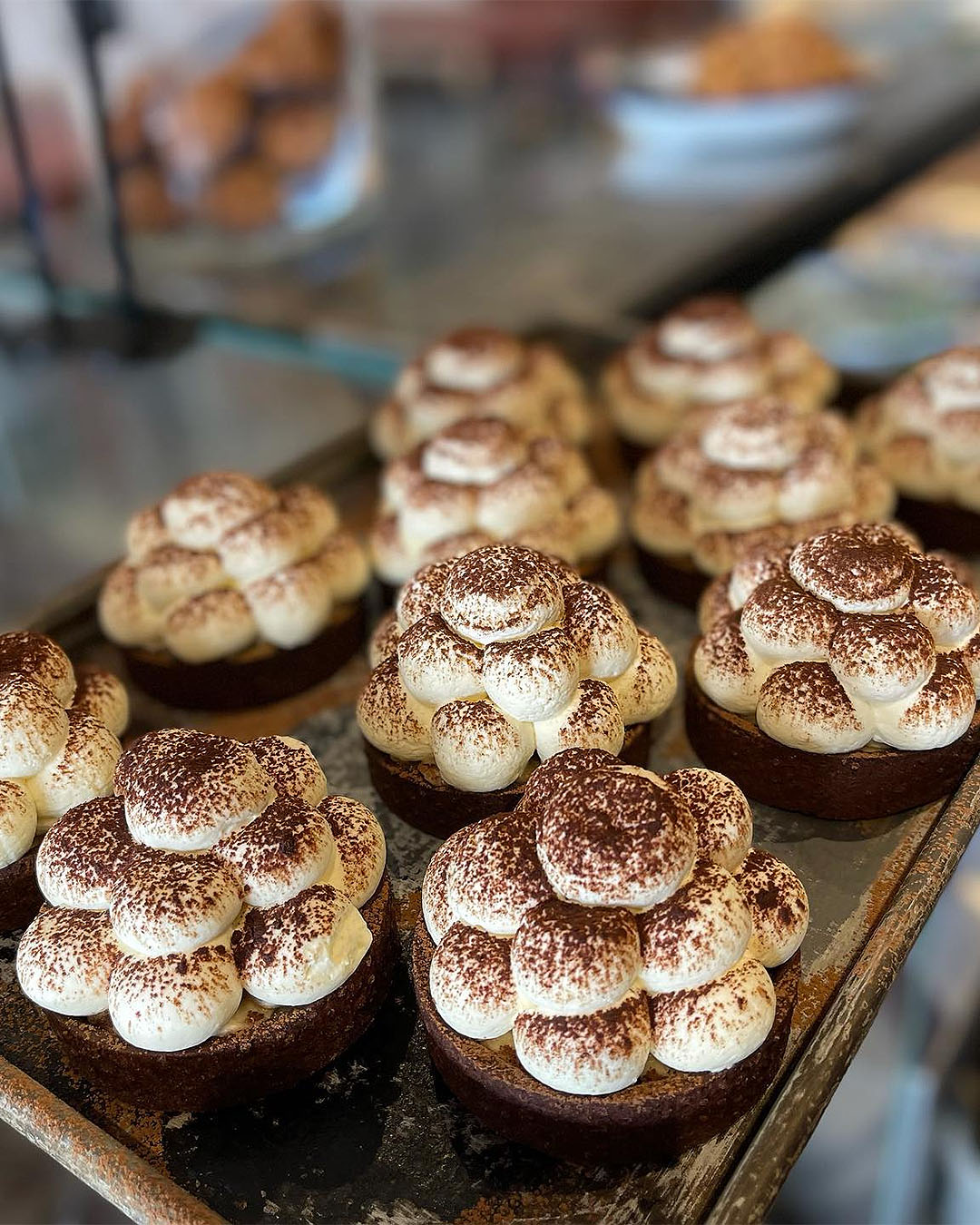 Banoffee pies topped with whipped cream and cocoa powder at Big Fig, one of the best restaurants in Wanaka.