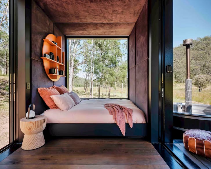 The bedroom with the hot tub outside at Billy's Hideaway cabin NSW