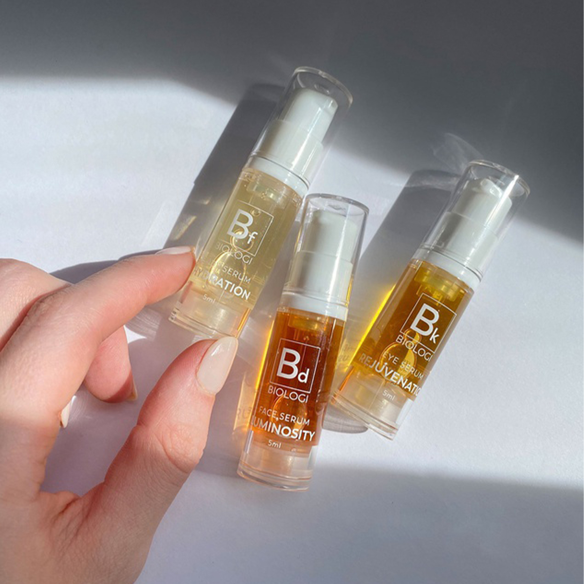 three mini biologi serum bottles