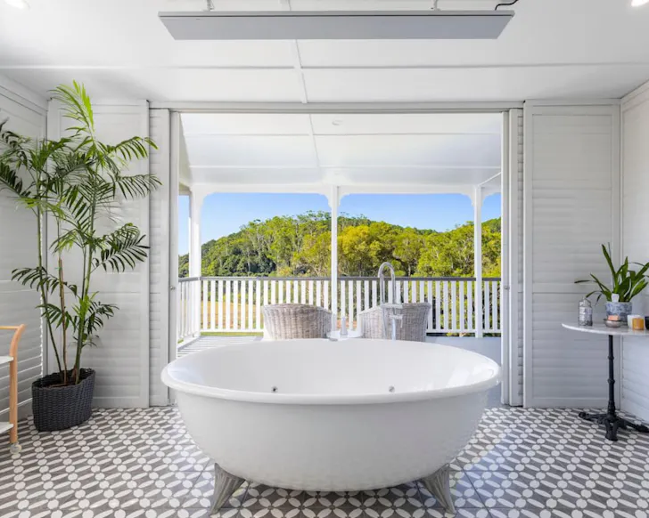 A view of the white bath with a view over the countryside at Bird Song Valley Airbnb near Brisbane Queensland