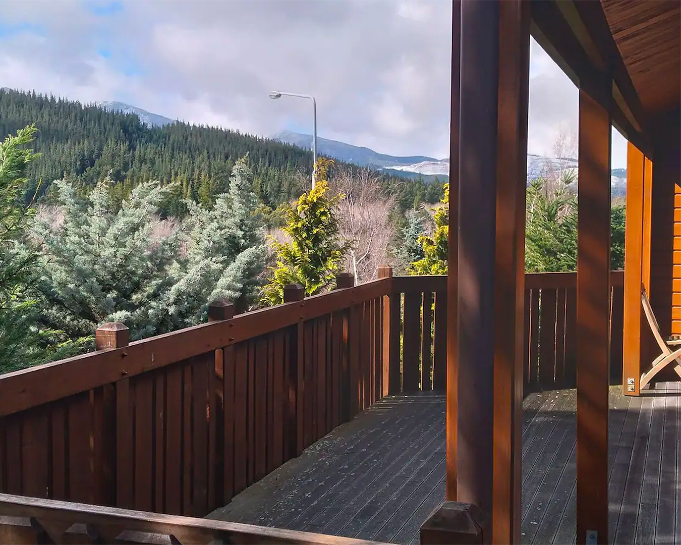 Black Bear Lodge in Hanmer springs looks out onto mountains and magical fir trees.