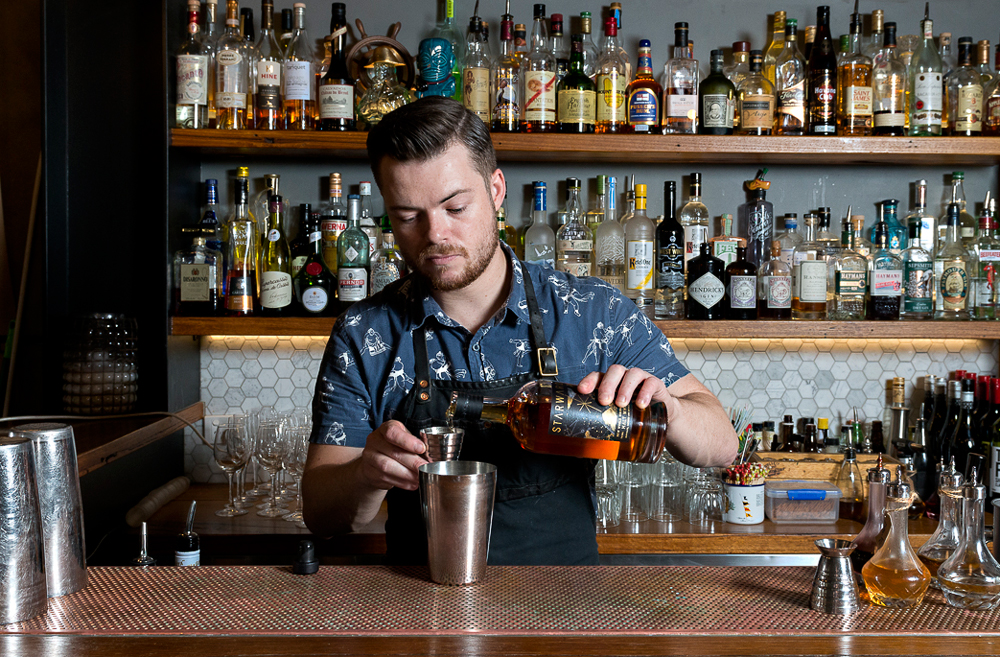 A master bartender making a bespoke cocktail at one of the best bars in Melbourne, The Black Pearl.
