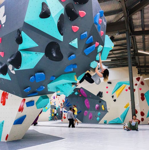A woman climbing one of the bouldering walls at Blochause in Marrickville in Sydney. 