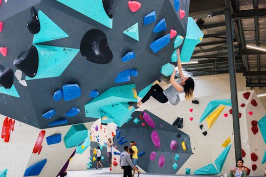 A woman climbing one of the bouldering walls at Blochause in Marrickville in Sydney.