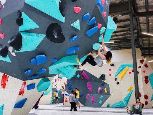 A woman climbing one of the bouldering walls at Blochause in Marrickville in Sydney. 