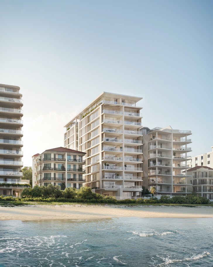 Beachfront residential apartment buildings overlooking the ocean, featuring modern architecture with glass balconies and coastal landscaping.
