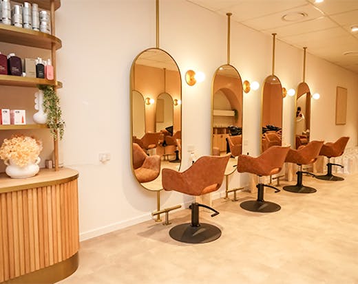 salon chairs in front of miroors