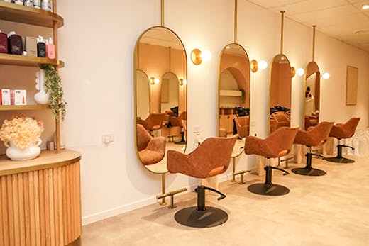 salon chairs in front of miroors