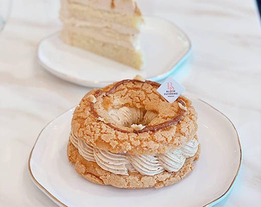 A filled doughnut and a slice of cake on a table