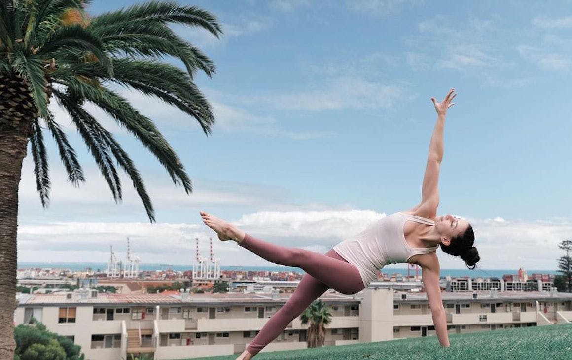 A yogi strikes a pose in a park