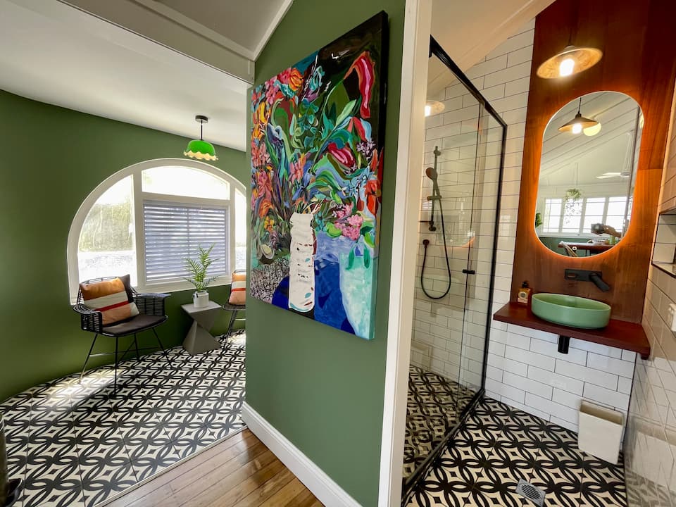 an art deco style apartment with green walls and black and white tiled floors