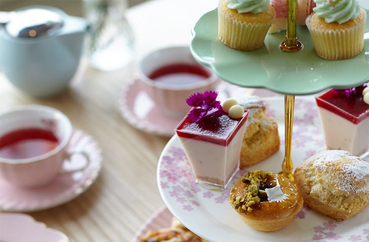 The high tea at Bluebells Cakery set out on delicate china.