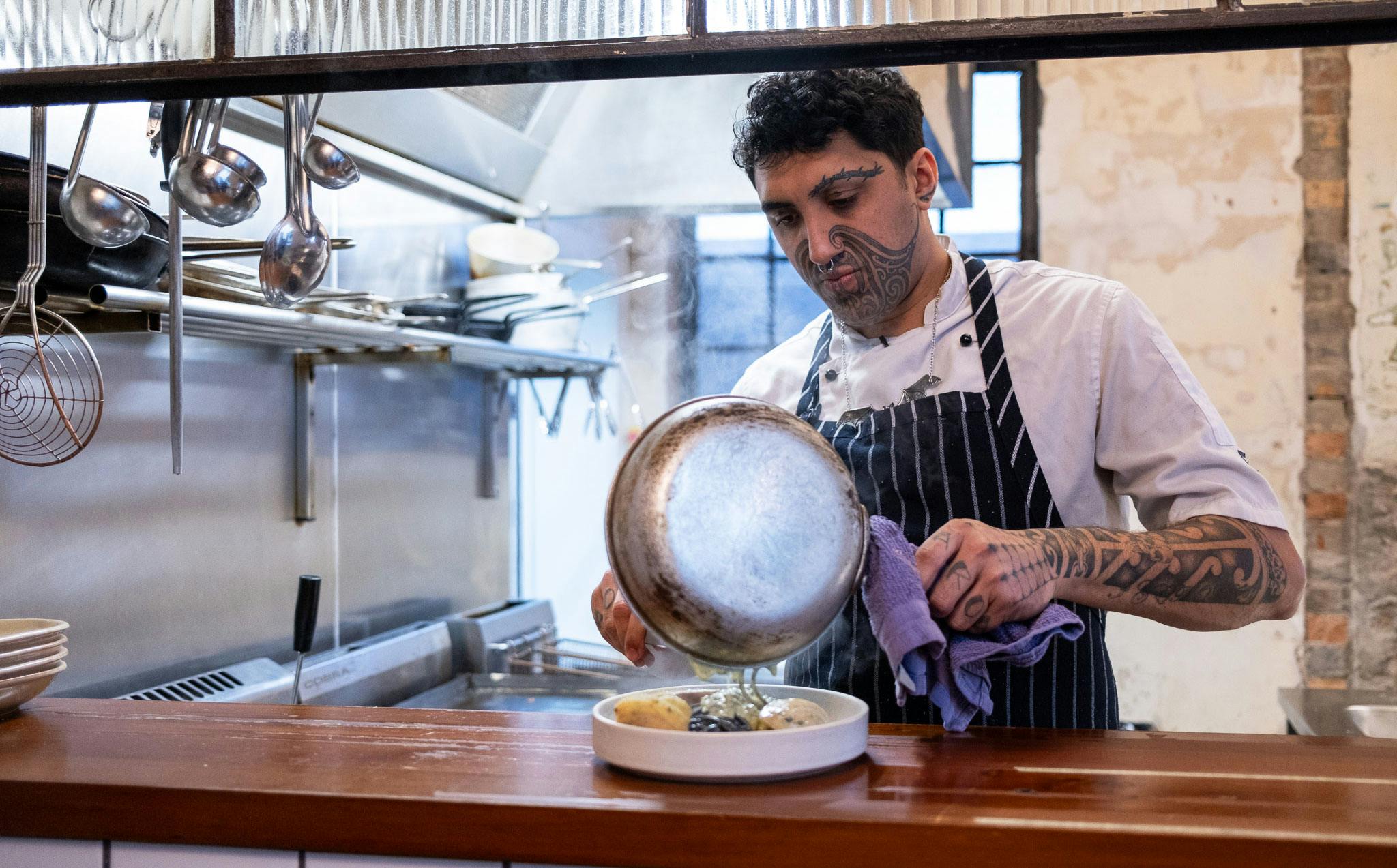 Kia Kanuta cooks a dish at Ada 