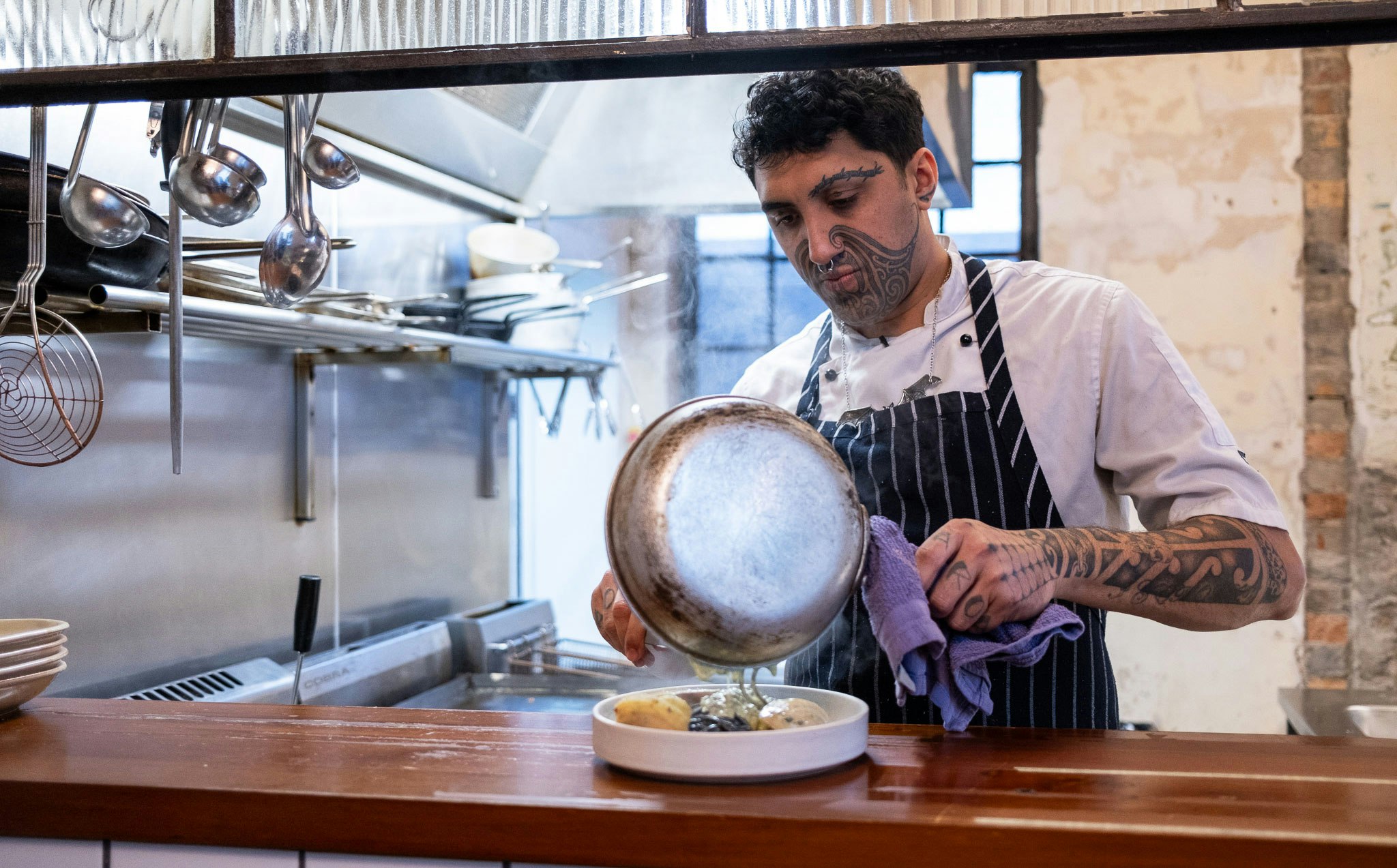 Kia Kanuta cooks a dish at Ada 