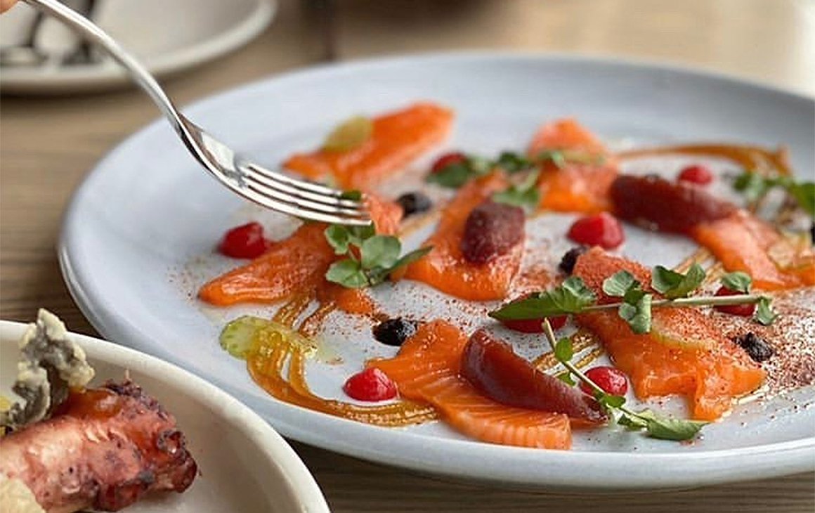 Small artfully arranged bites of sashimi sit on a plate at Boardwalk.