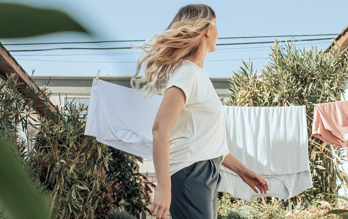 woman in a t-shirt in front of a washing line