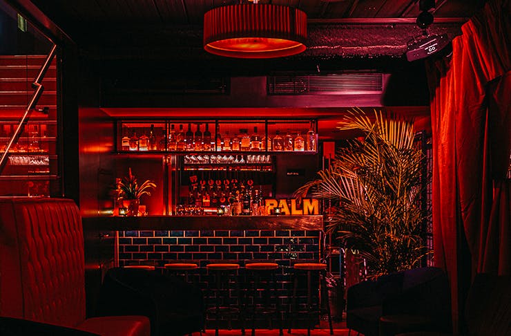 An underground speakeasy bar wrapped in red velvet.