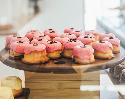 pink icing topped mini bund cakes on a tray
