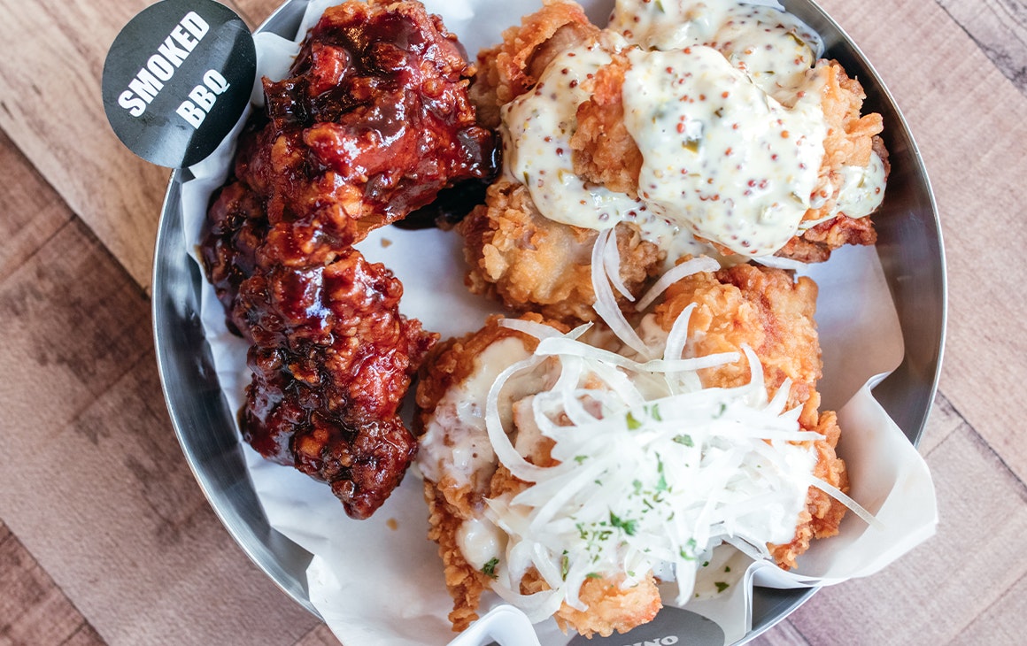 a bowl of three different types of wings 