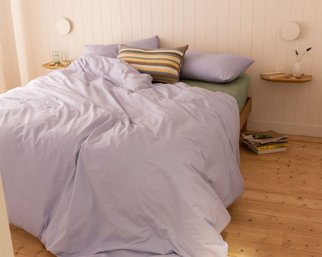 A bed made with mauve sheets from Sheet Society, which are on sale for Boxing Day