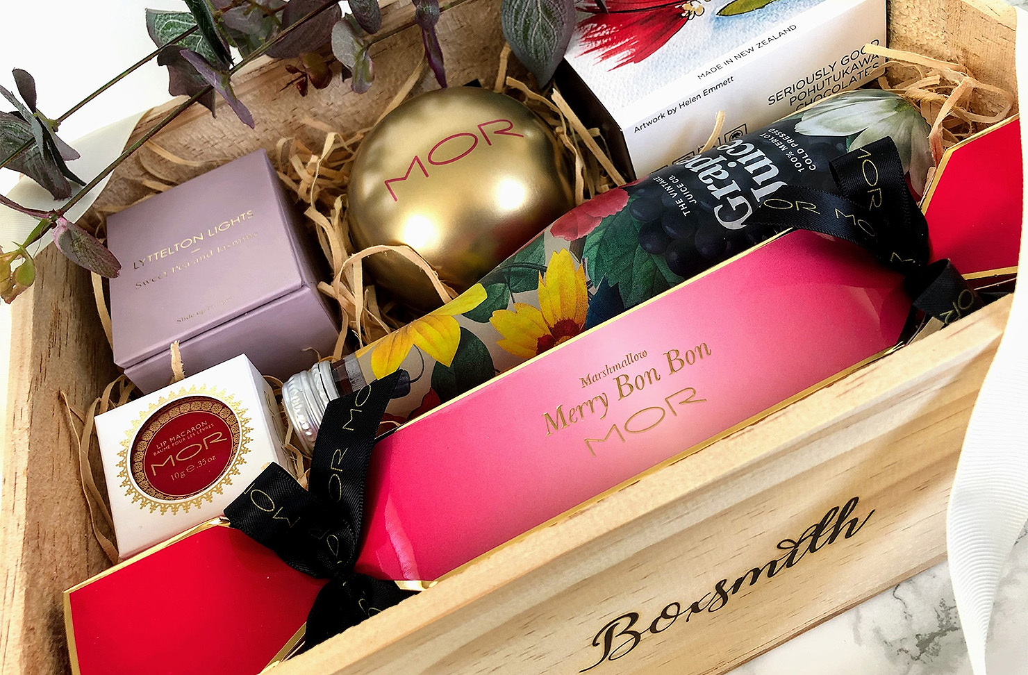 A Christmas gift box from Boxsmith showing a packed box of goodies for Christmastime.
