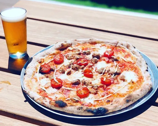 A Braeside Brewing Co pizza next to one of their beers.