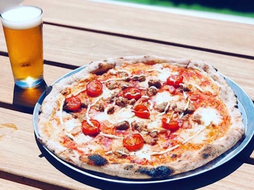 A Braeside Brewing Co pizza next to one of their beers.