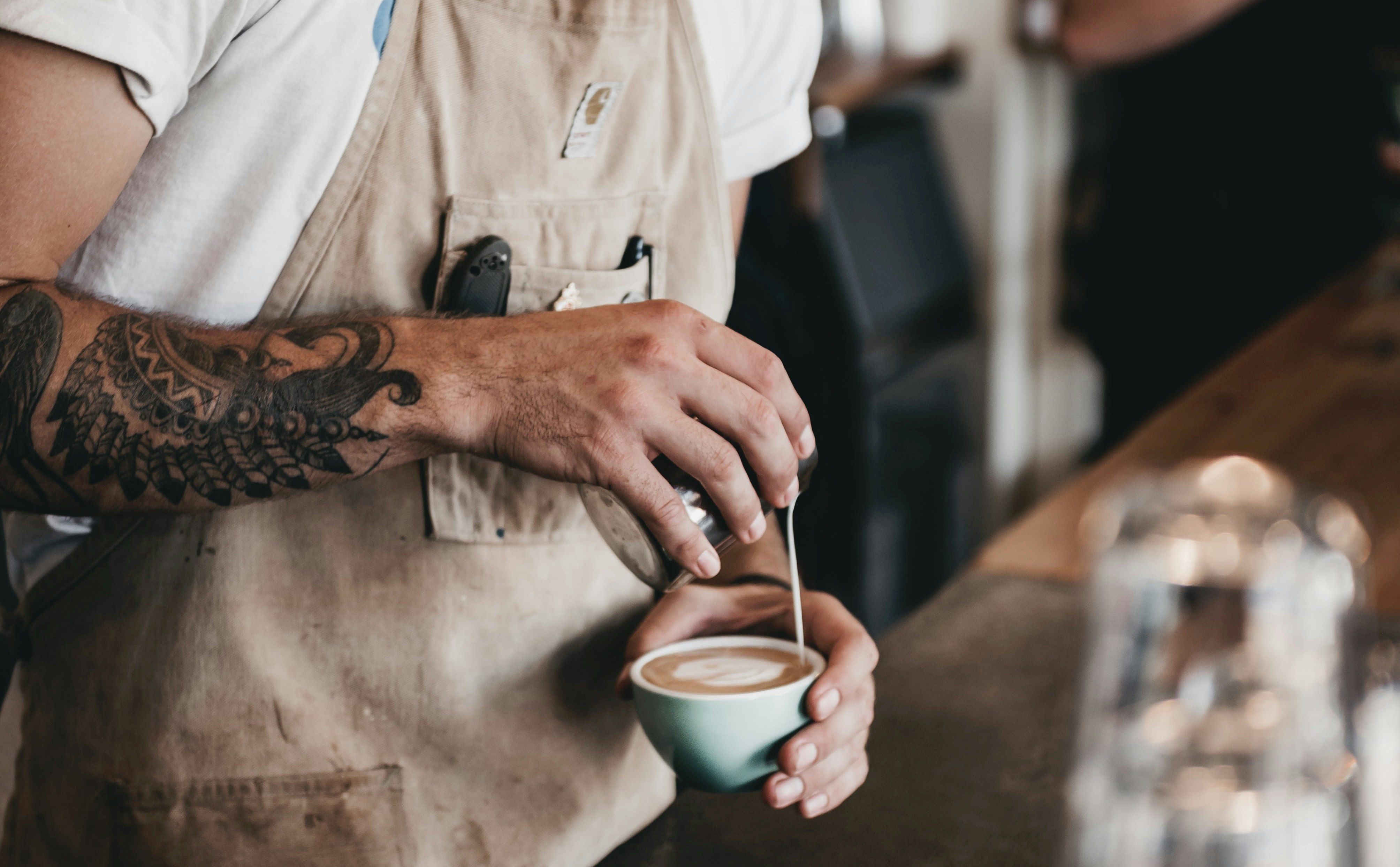 A barista brews a perfect coffee in a cafe.