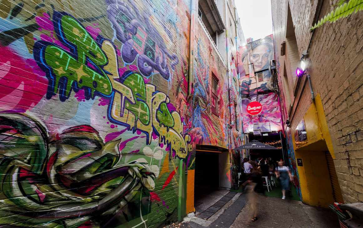 a cafe down a laneway covered in graffiti