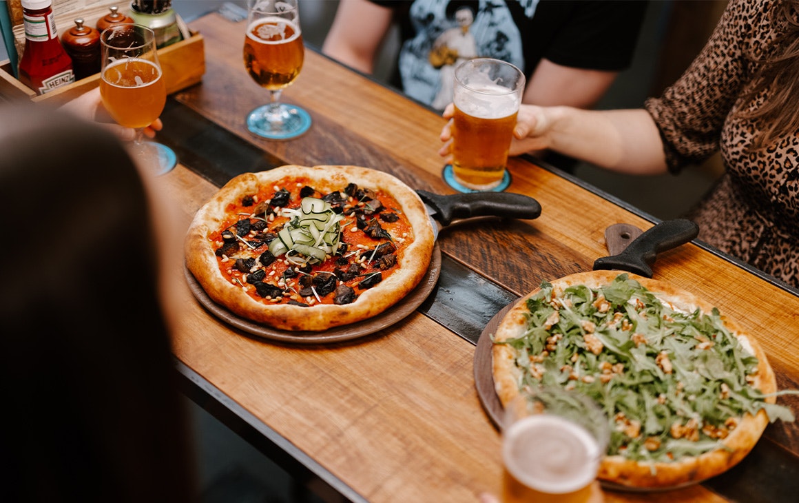 pizzas and beers on a table