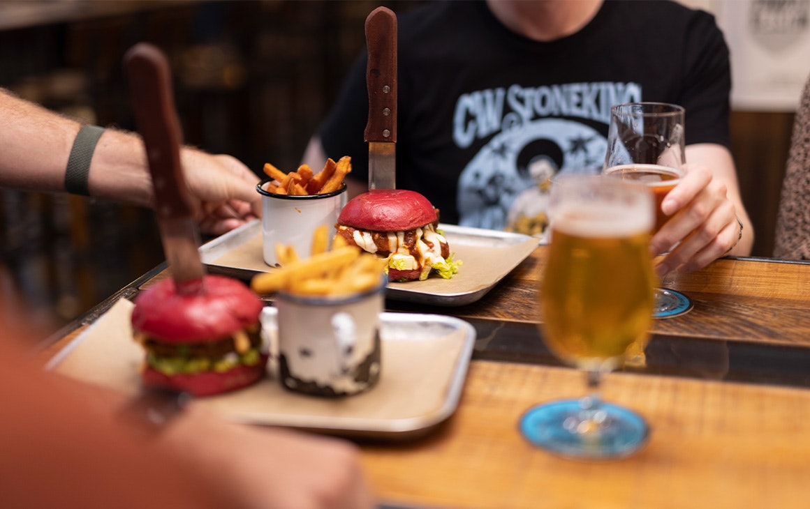 burgers and beers on a table