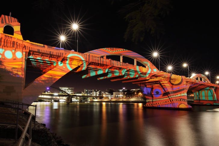 William Jolly Bridge lit up with artwork projected onto it 