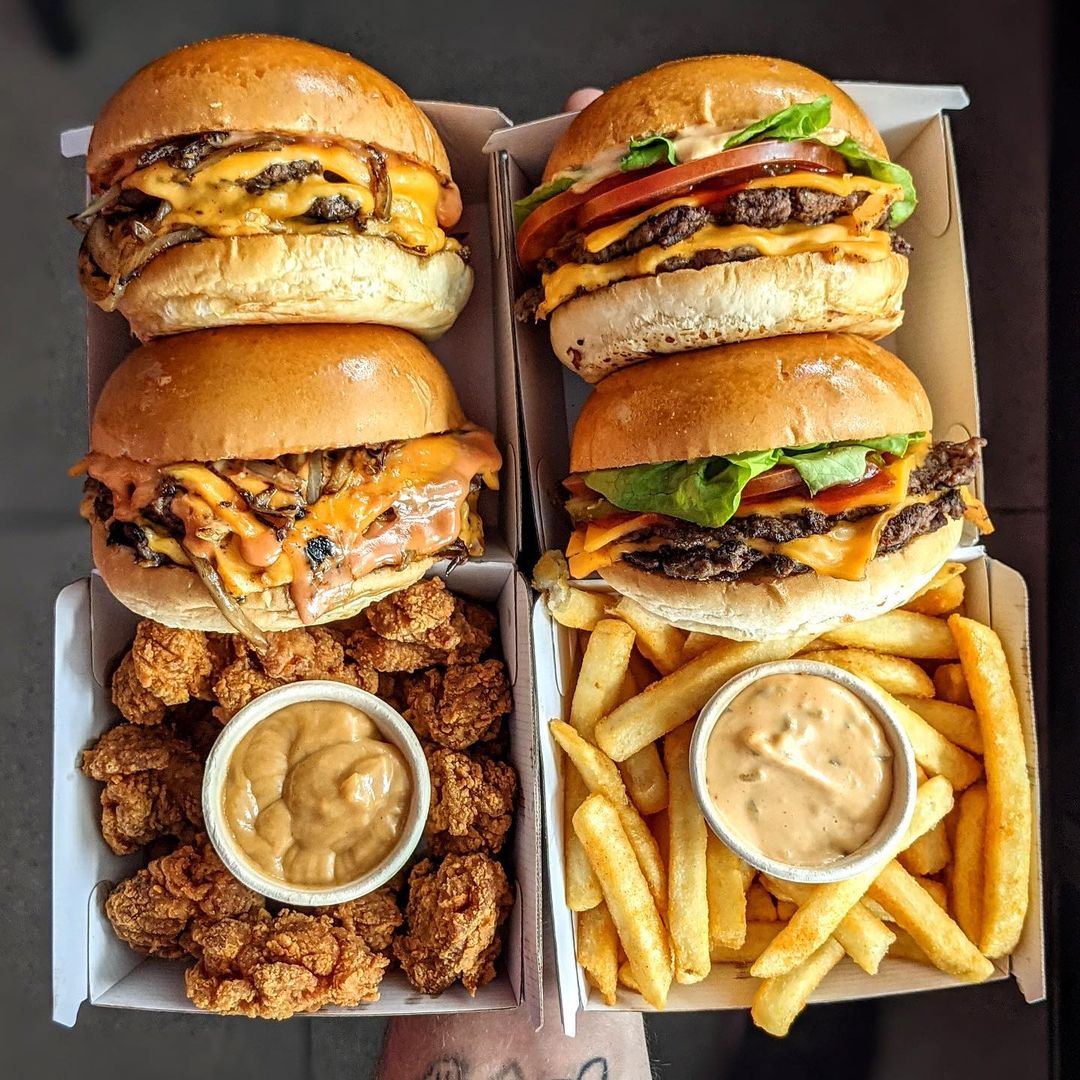 burgers and fries in a takeaway container