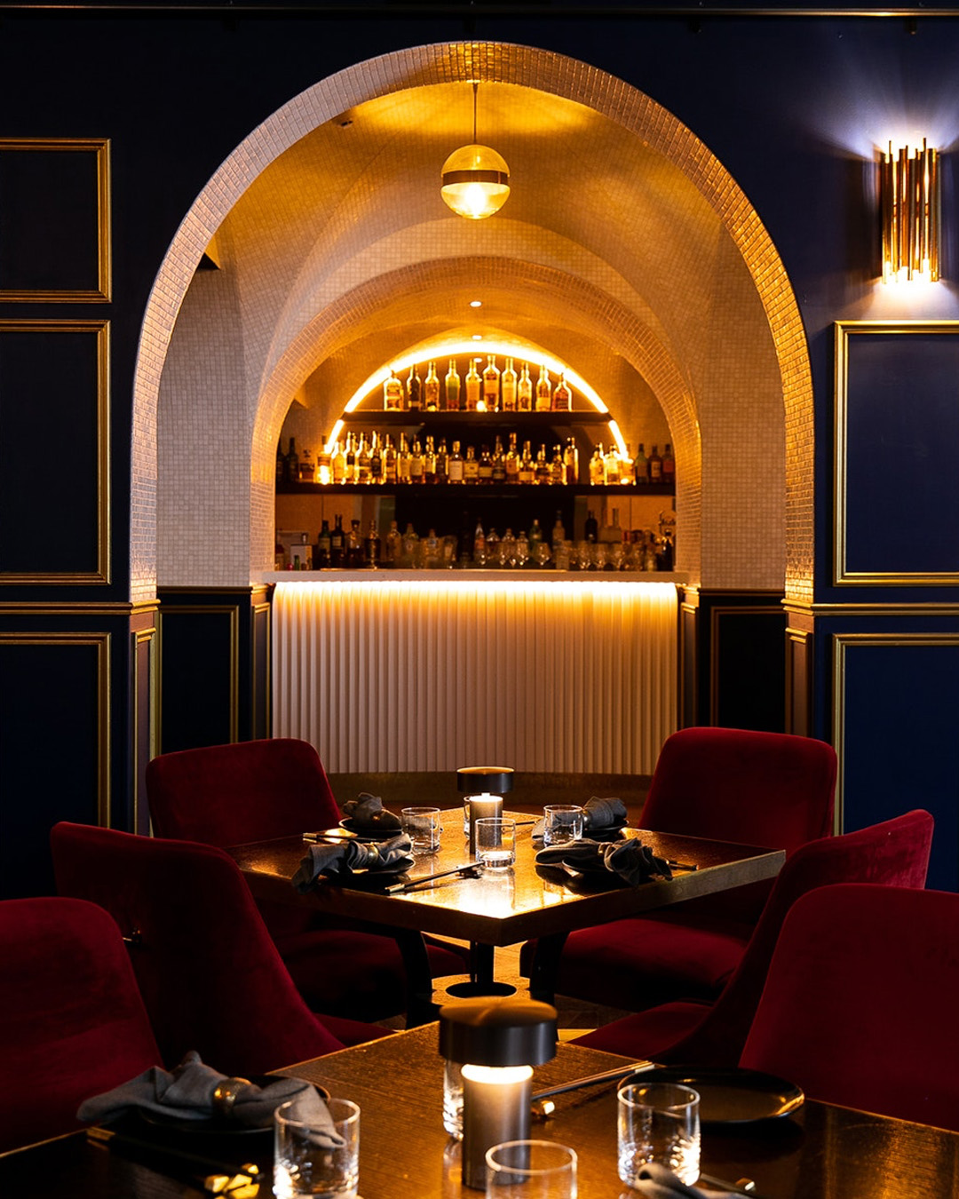 a dark and moody seating area by a bar at brisbane cbd restaurant boom boom