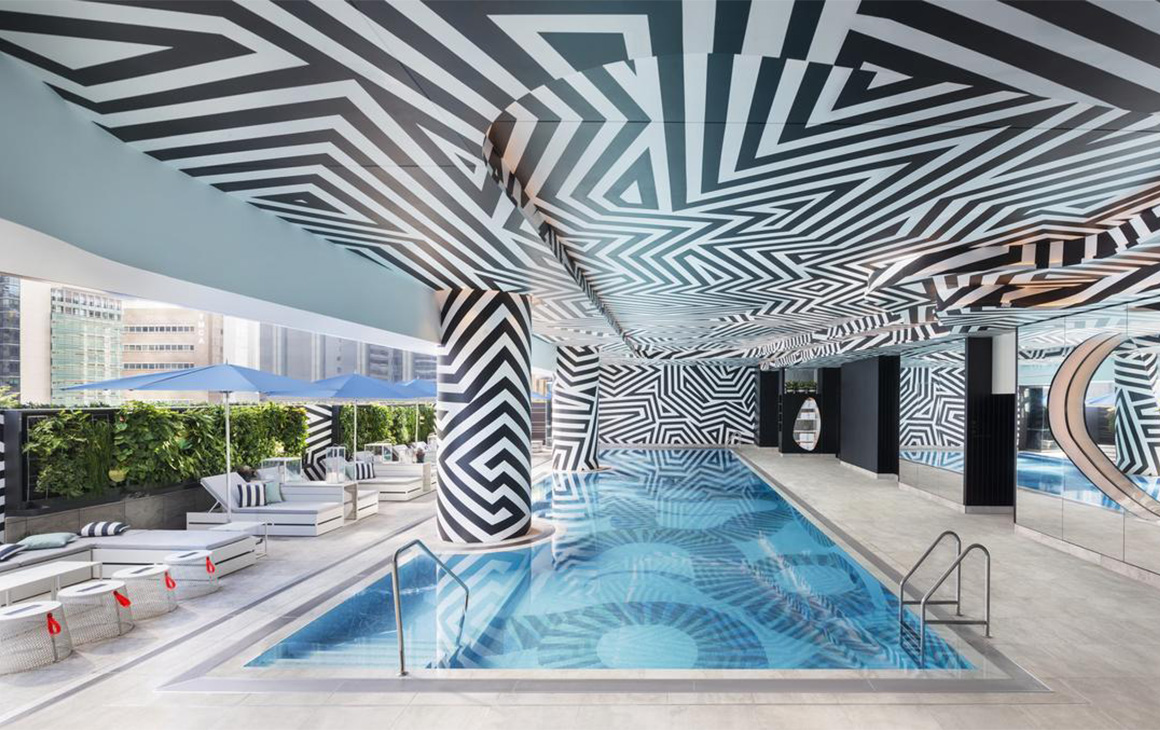 a pool under a psychadelic rooftop at W Brisbane hotel