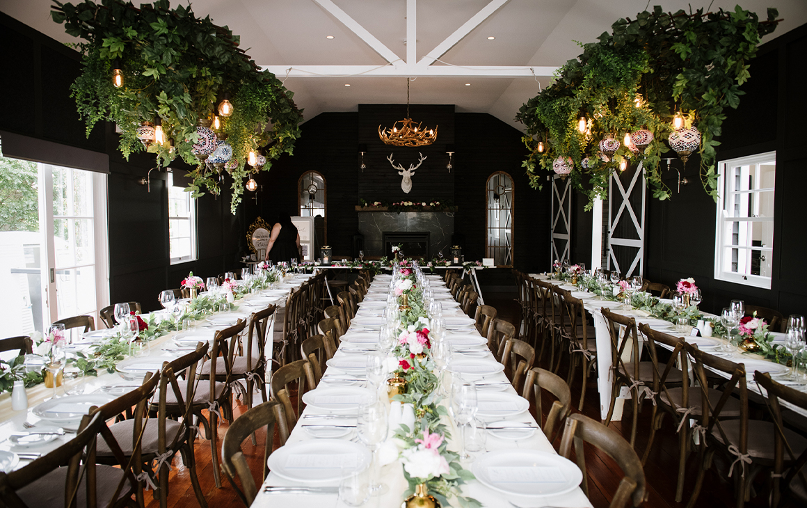 banquet tables in a black hall at a a wedding venue near brisbane