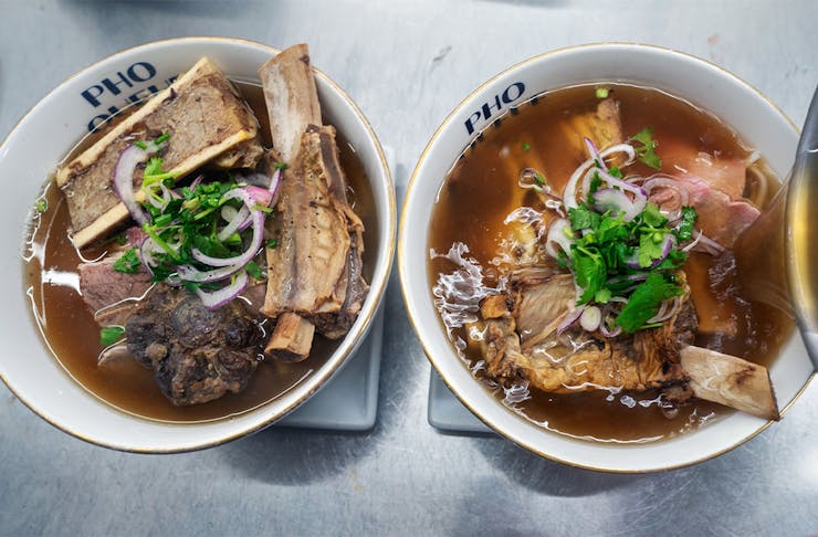 two bowls of pho side by side