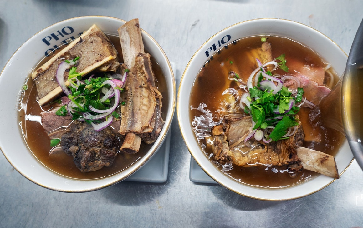 two bowls of pho side by side