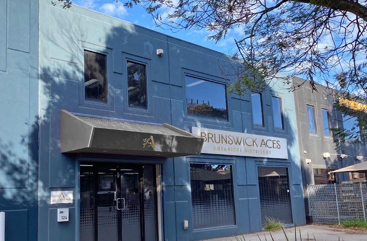 The facade of a bar painted blue with a logo on the front that reads 