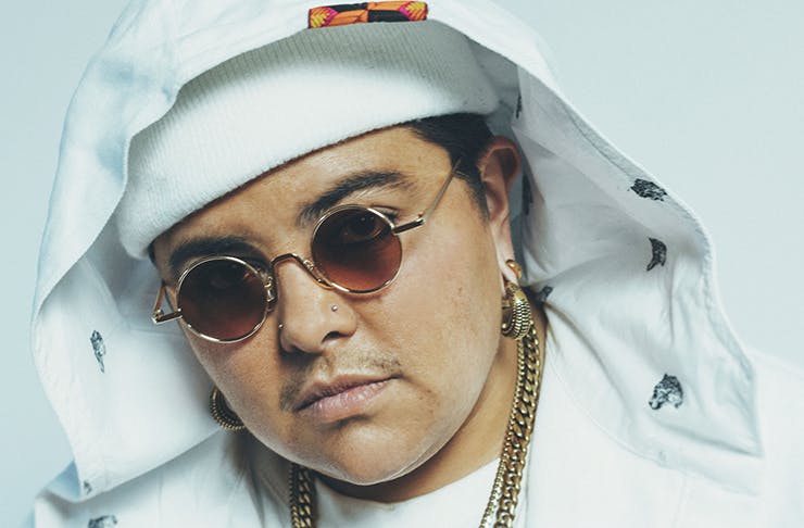 Artist Mo'Ju in a white beanie and sunglasses.