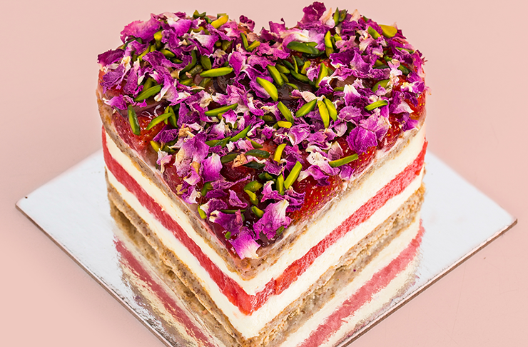 A heart-shaped cake on a silver tray.