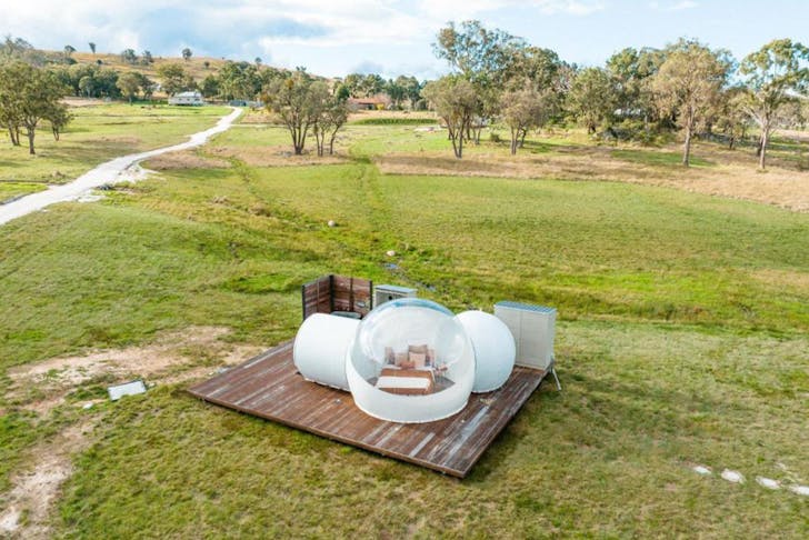 a bubble tent surrounded by countryside