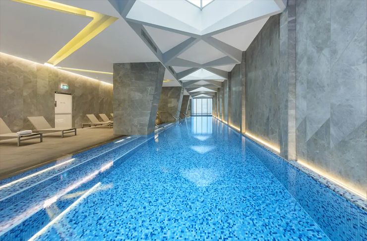 A long neon-lit hotel pool.