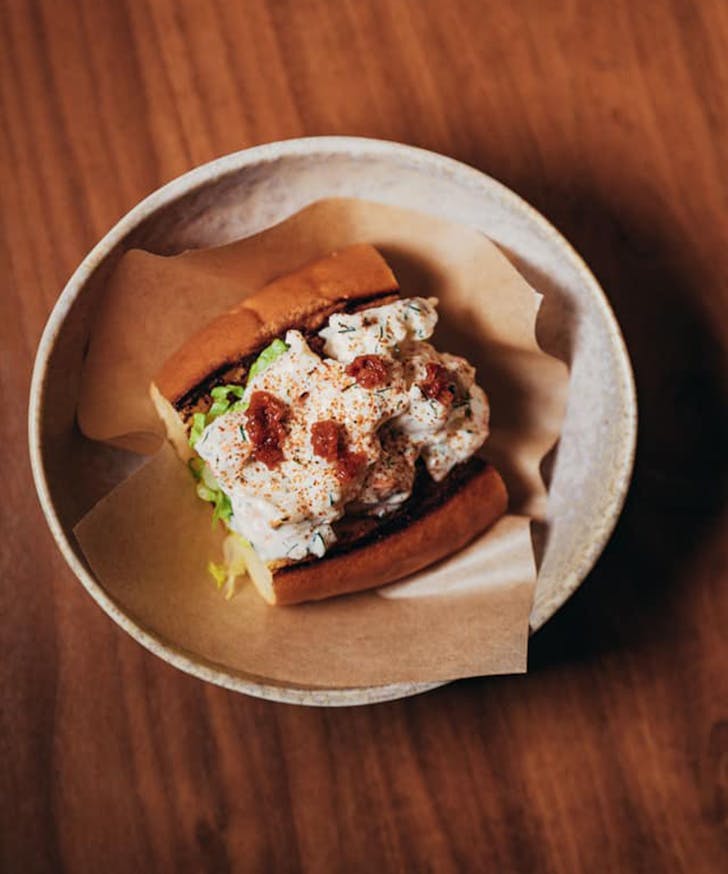 a saucy bug roll in a bowl