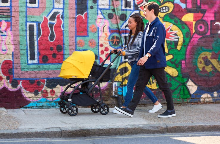 Young parents pushing a Bugaboo Bee 6 pram. 