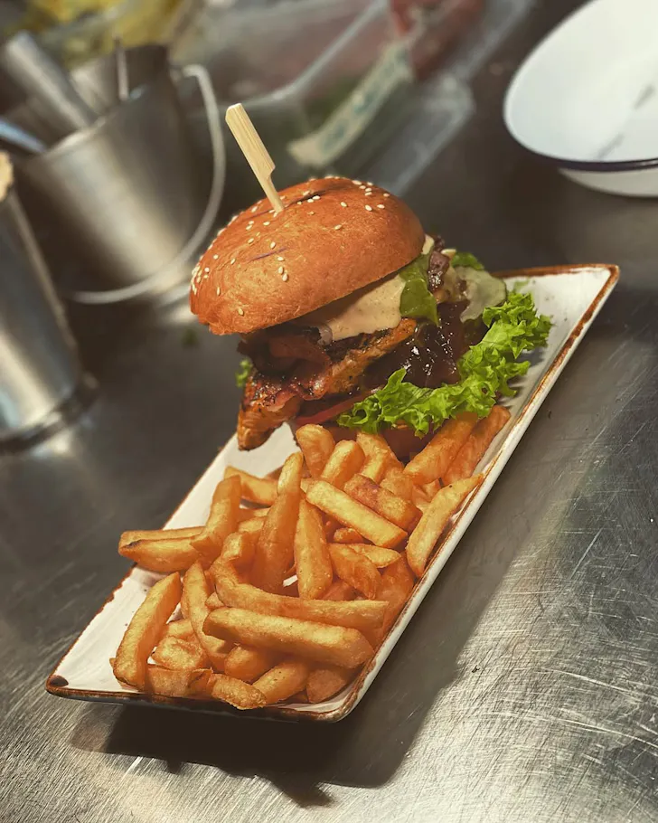 A burger and fries on a tray at The Paddington.