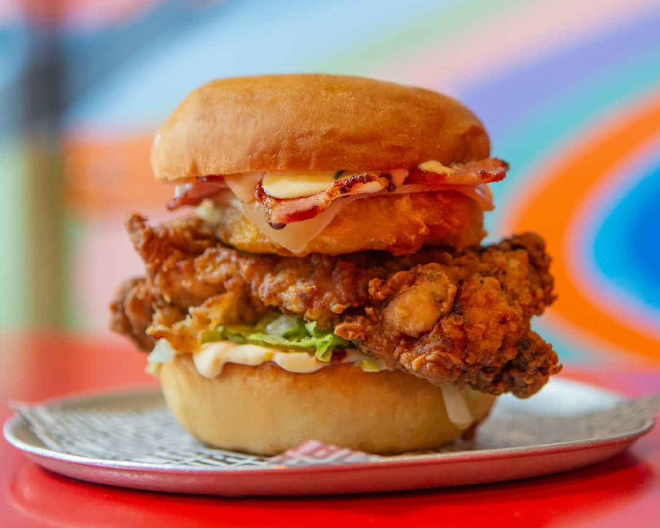 Up close and personal with a delicious, crispy fried chicken burger from Burger Liquor