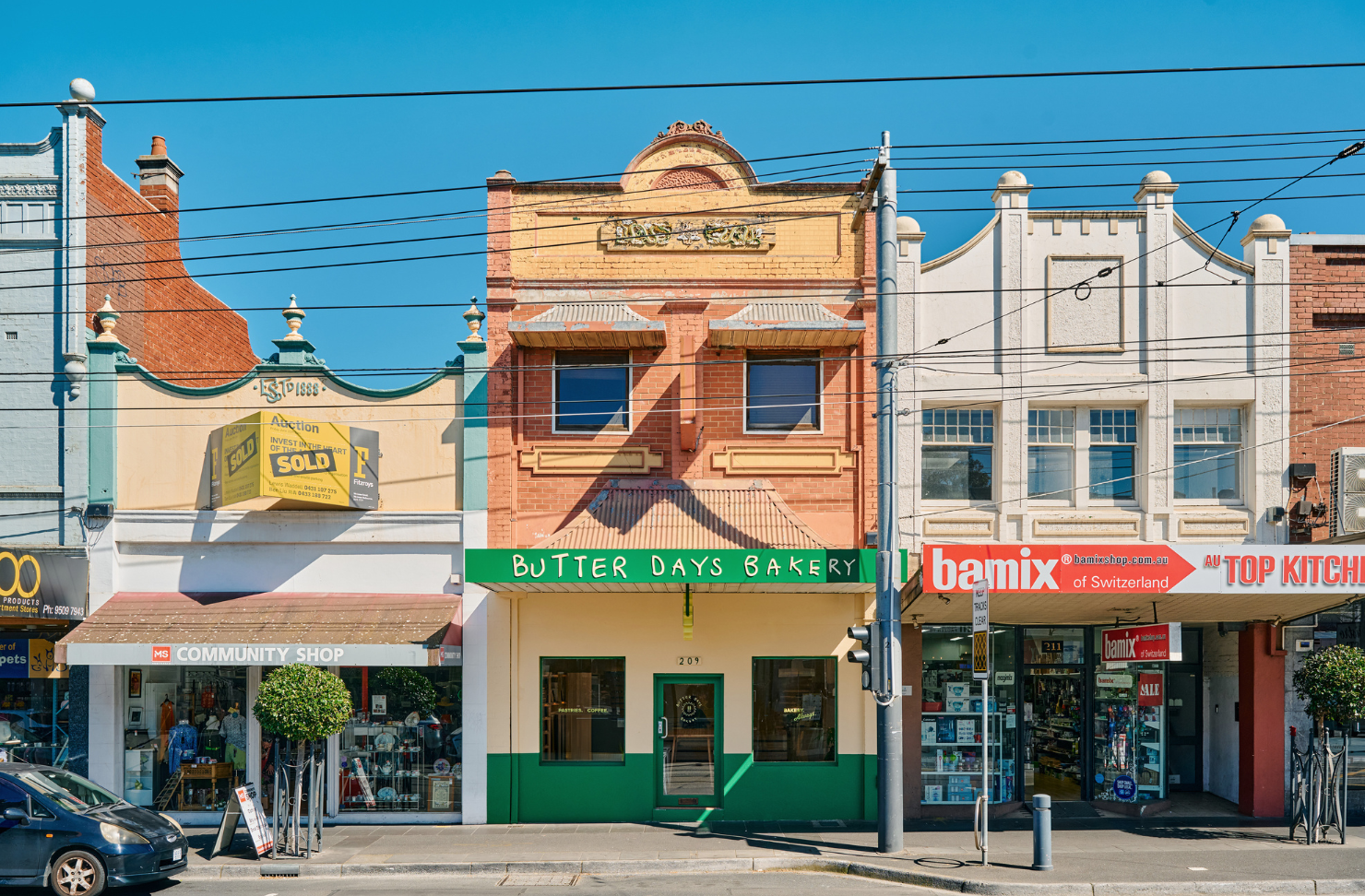 A shopping strip in Malvern, centre shop-front is Butter Days Bakery