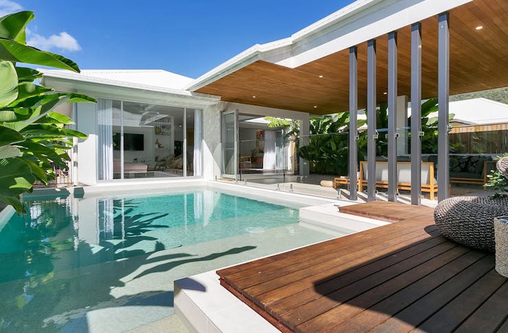 a pool next to a luxurious summer house