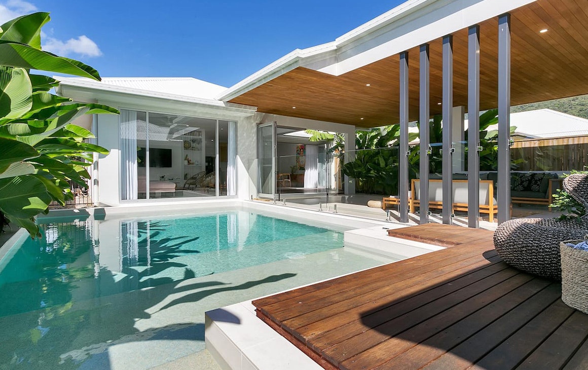 a pool next to a luxurious summer house